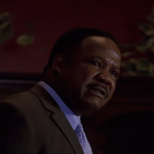 a man in a suit and tie says eeee